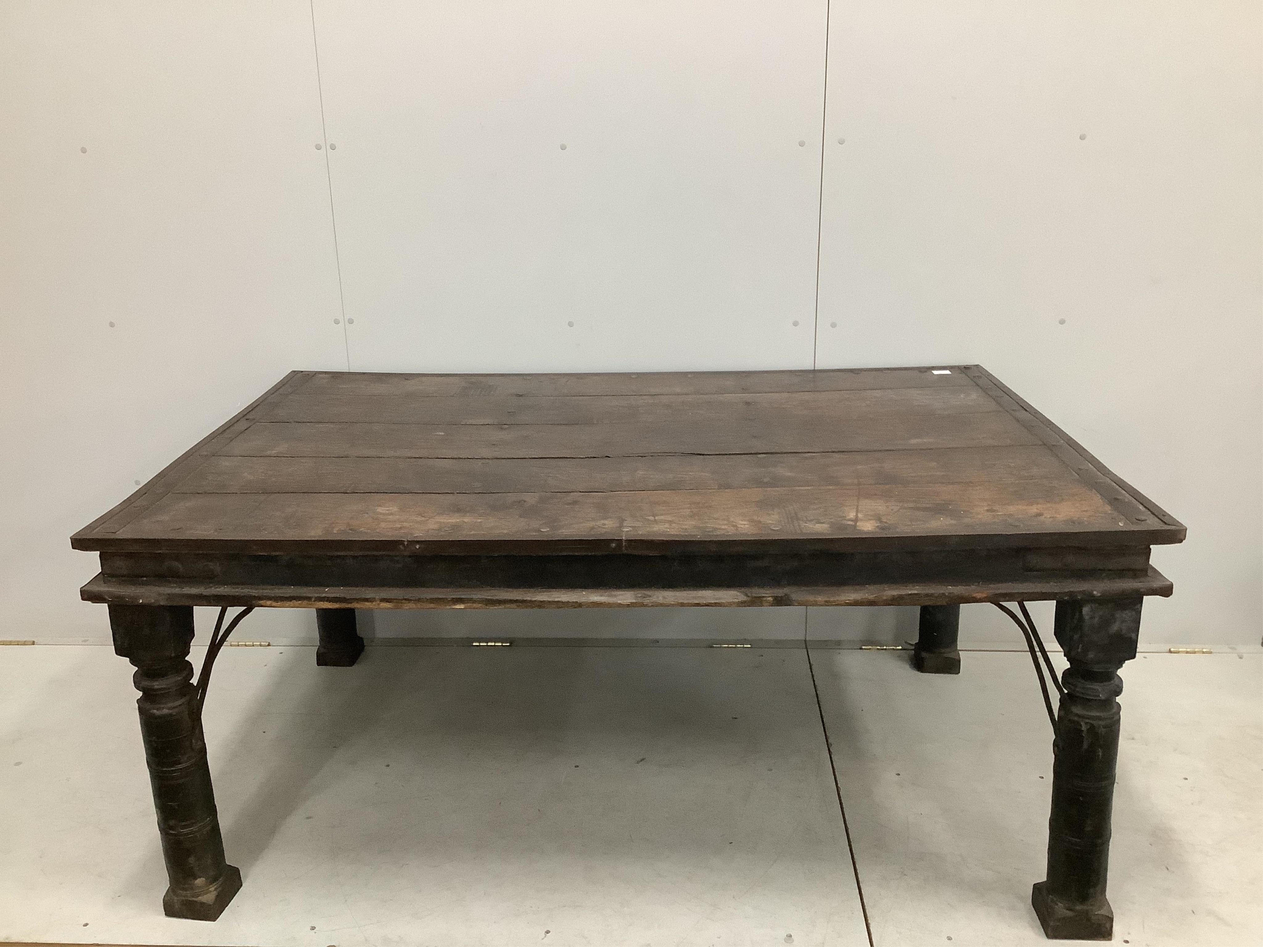 An Indian iron studded hardwood dining table, width 176cm, depth 116cm, height 78cm. Condition - fair